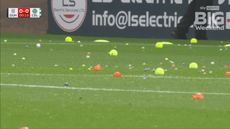 Raging Celtic fans cause delay in game against Dundee by throwing BALLS and ORANGES onto pitch in latest board protest