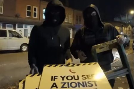 Masked protesters, ‘not welcome’ signs & a 700-police ring of steel